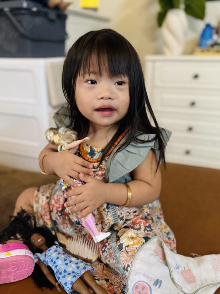 Alashi sitting on a sofa with a book